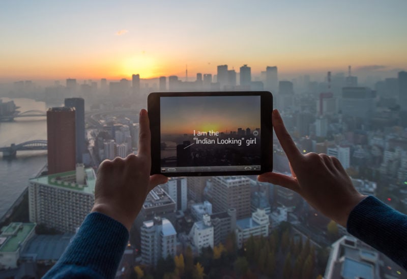 Girl taking picture of Tokyo with tablet